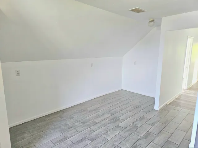 an empty room with wooden floor