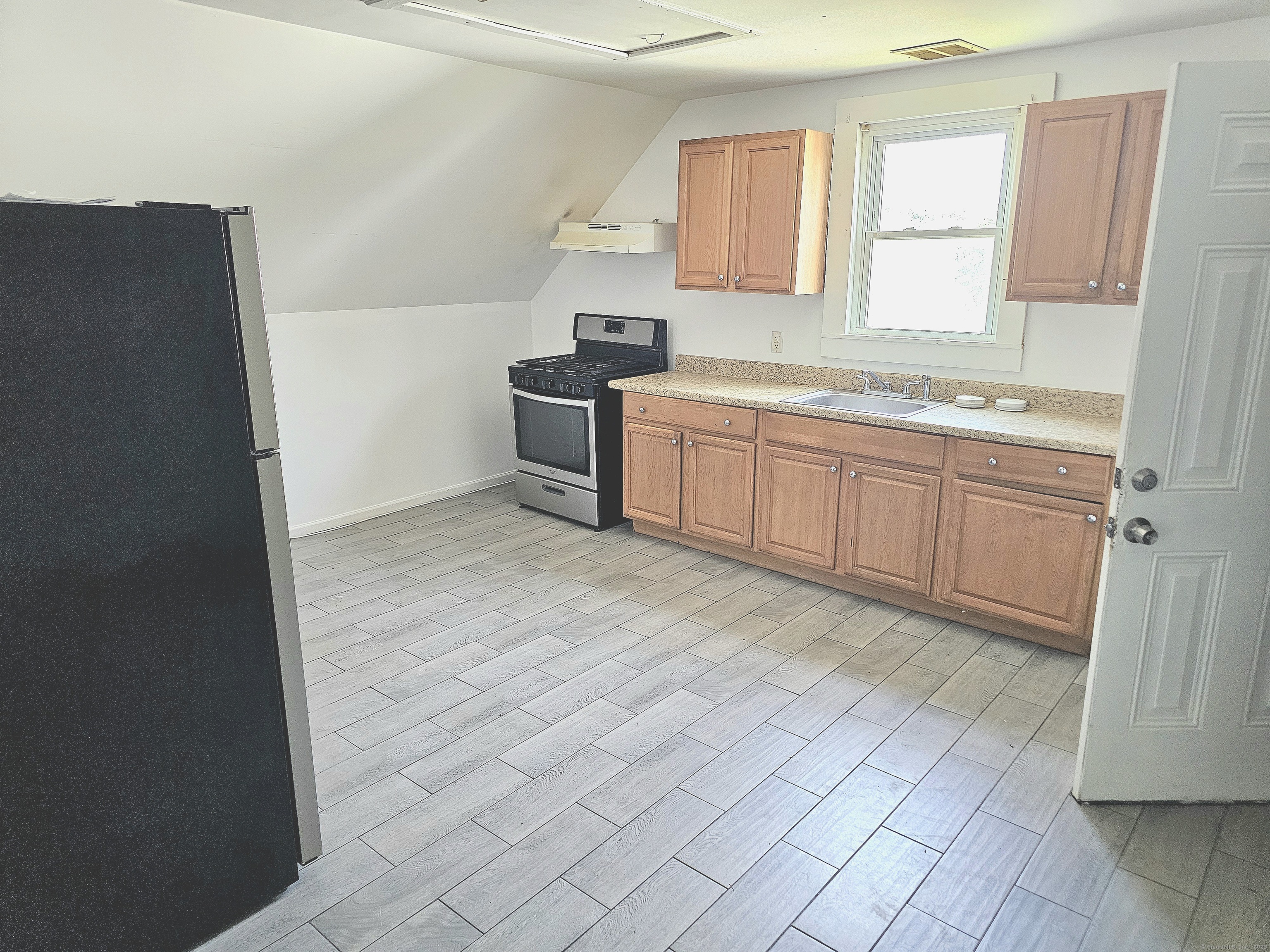 483 Ferry Street, Unit 3 New Haven, CT 06513 - Photo 8 of 10 a spacious bathroom with a granite countertop sink a mirror and a bathtub