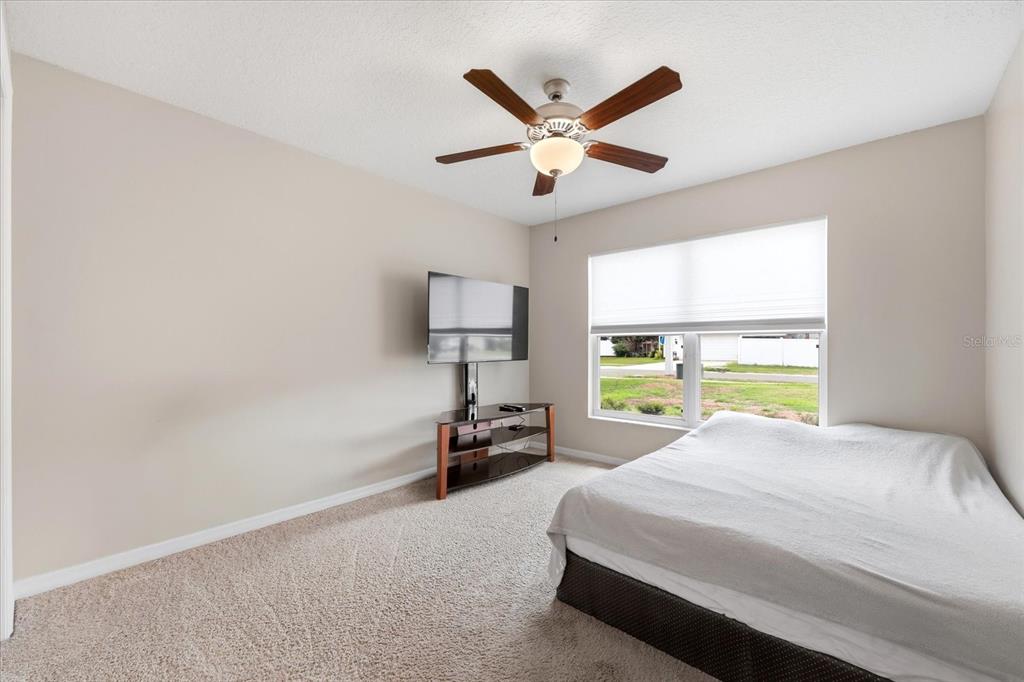 224 Bryan Oak Avenue Brandon, FL 33511 - Photo 15 of 33 a bed sitting in a bedroom next to a window