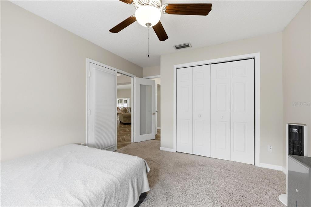 224 Bryan Oak Avenue Brandon, FL 33511 - Photo 16 of 33 a bedroom with a bed and a chandelier