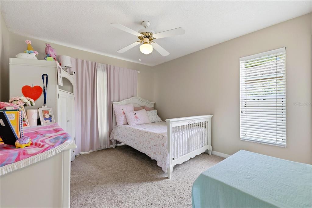 224 Bryan Oak Avenue Brandon, FL 33511 - Photo 18 of 33 a bedroom with a bed and a chandelier