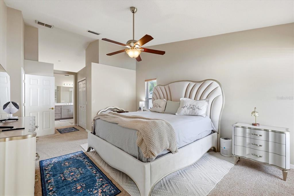 224 Bryan Oak Avenue Brandon, FL 33511 - Photo 22 of 33 a spacious bedroom with a bed and a chandelier