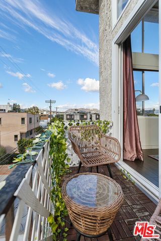 a view of a balcony with chair and table