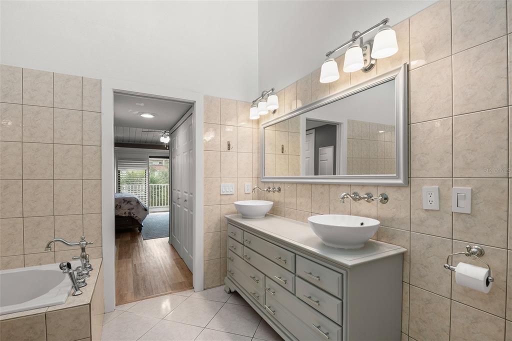 529 Sandy Hook Road Treasure Island, FL 33706 - Photo 30 of 55 a spacious bathroom with a double vanity sink mirror and bathtub