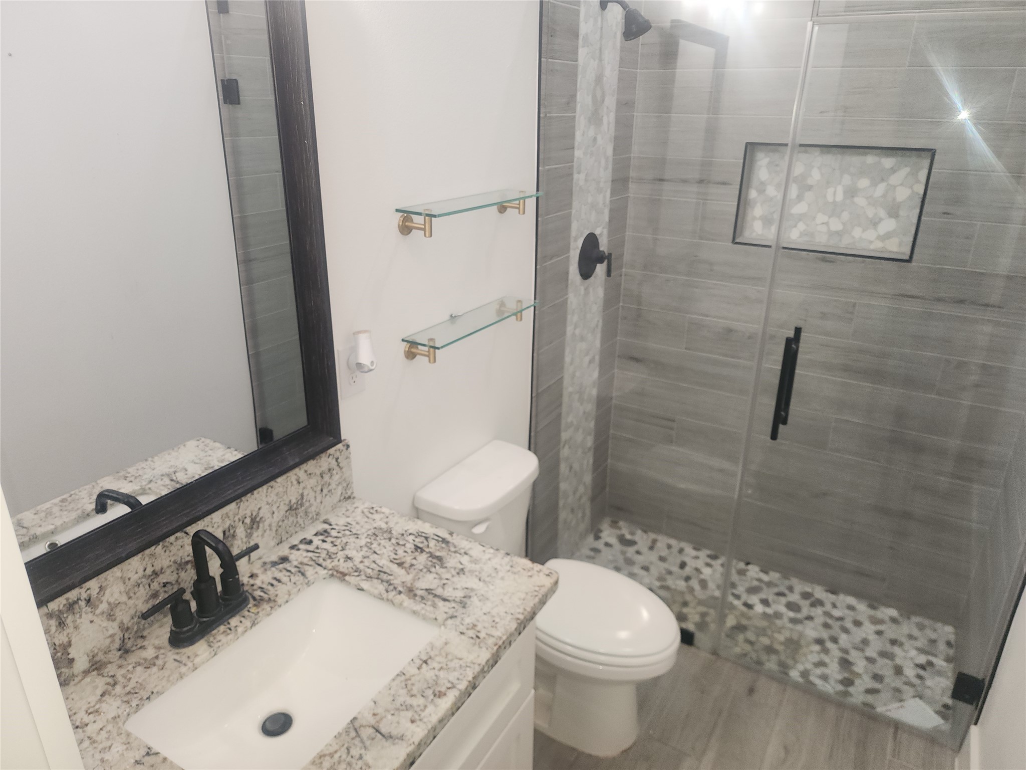 214 Lakeland Circle Rosharon, TX 77583 - Photo 9 of 34 a bathroom with a sink toilet and shower