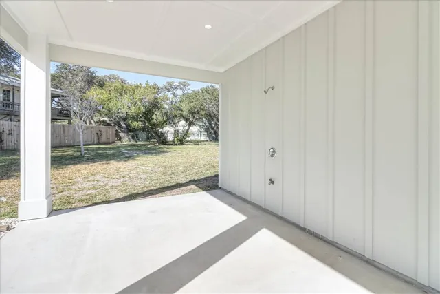 a living room with stainless steel appliances furniture and a kitchen view
