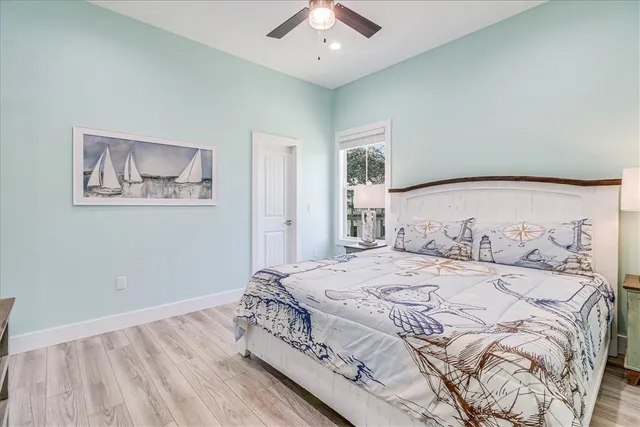a bedroom with two beds and a large window