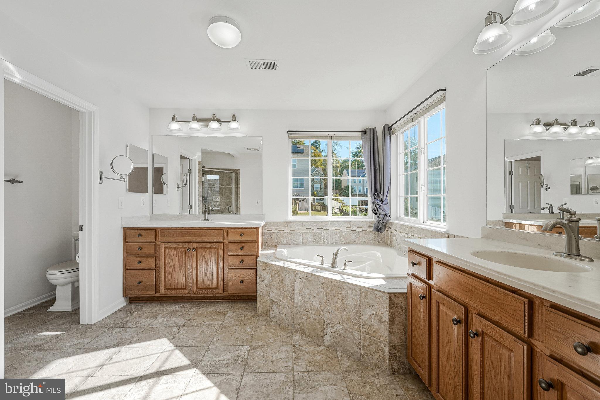 16012 Imperial Eagle Court Woodbridge, VA 22191 - Photo 11 of 25 a spacious bathroom with a tub sink and mirror