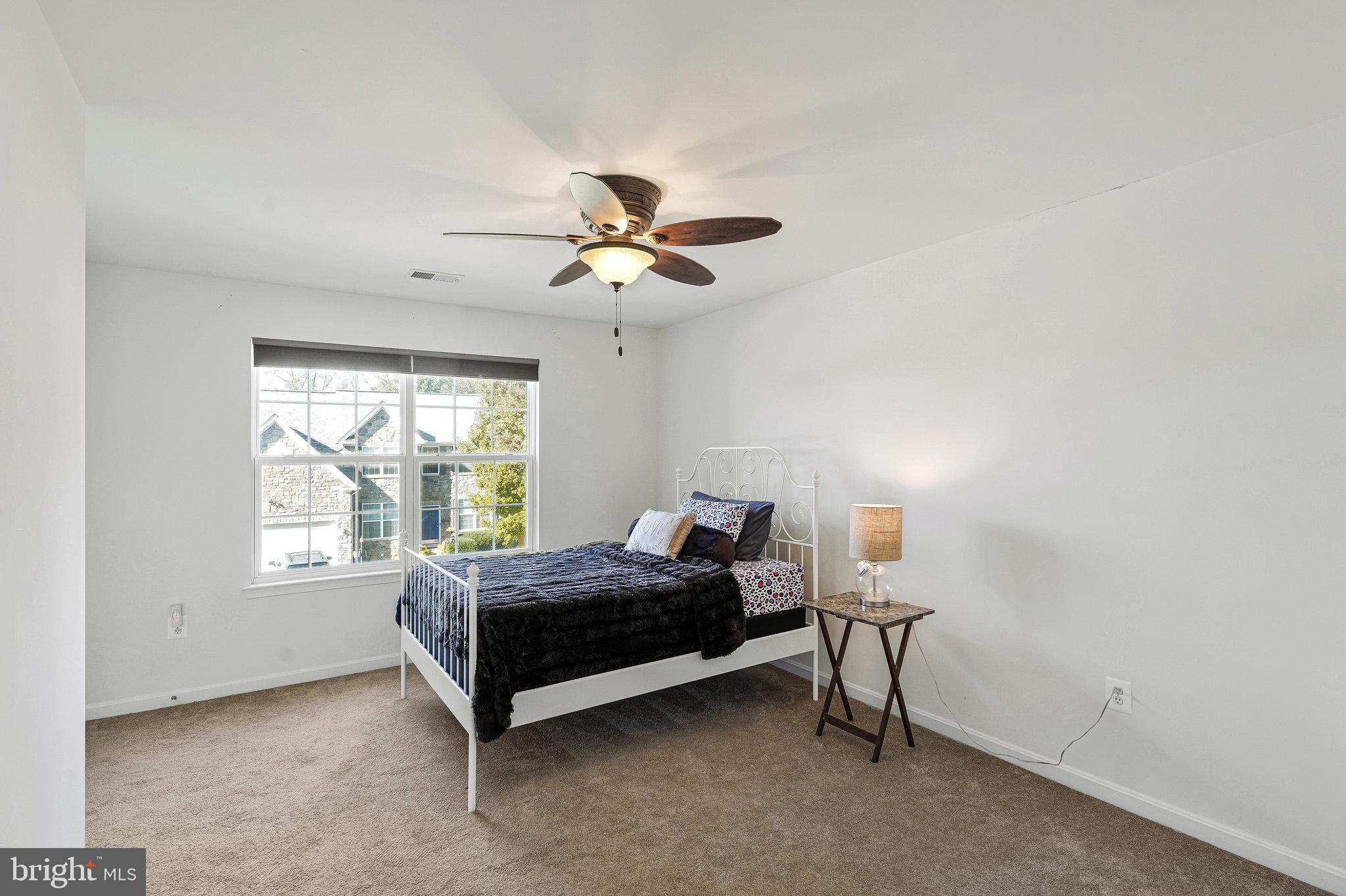 16012 Imperial Eagle Court Woodbridge, VA 22191 - Photo 14 of 25 a room with a bed and a chandelier