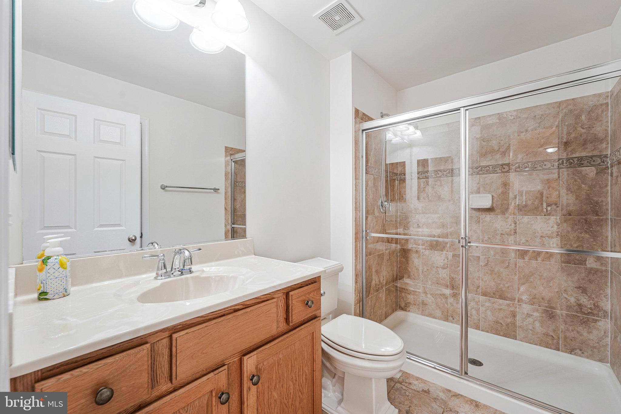 16012 Imperial Eagle Court Woodbridge, VA 22191 - Photo 15 of 25 a bathroom with a sink toilet and shower