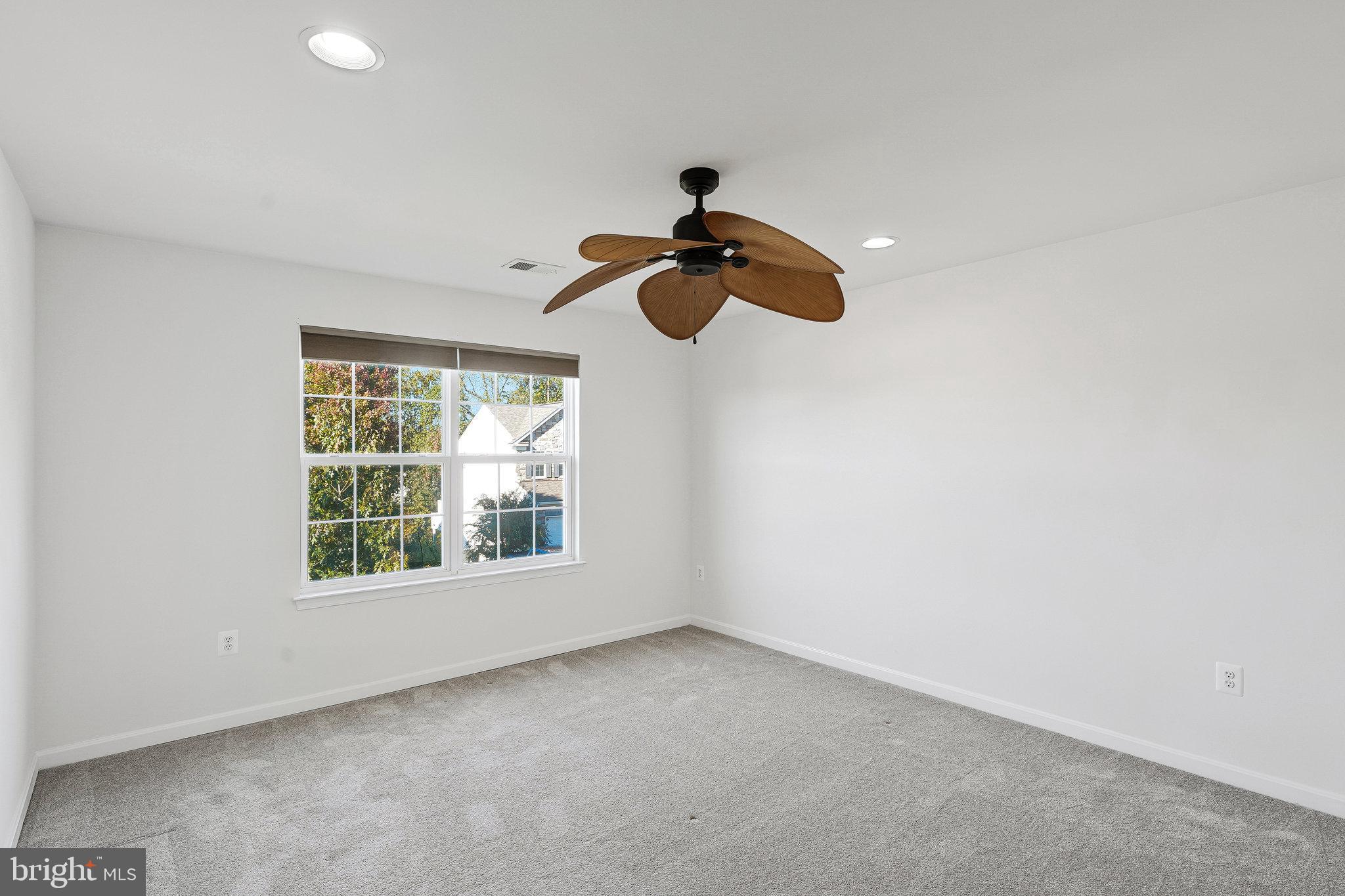 16012 Imperial Eagle Court Woodbridge, VA 22191 - Photo 18 of 25 an empty room with a window and a ceiling fan