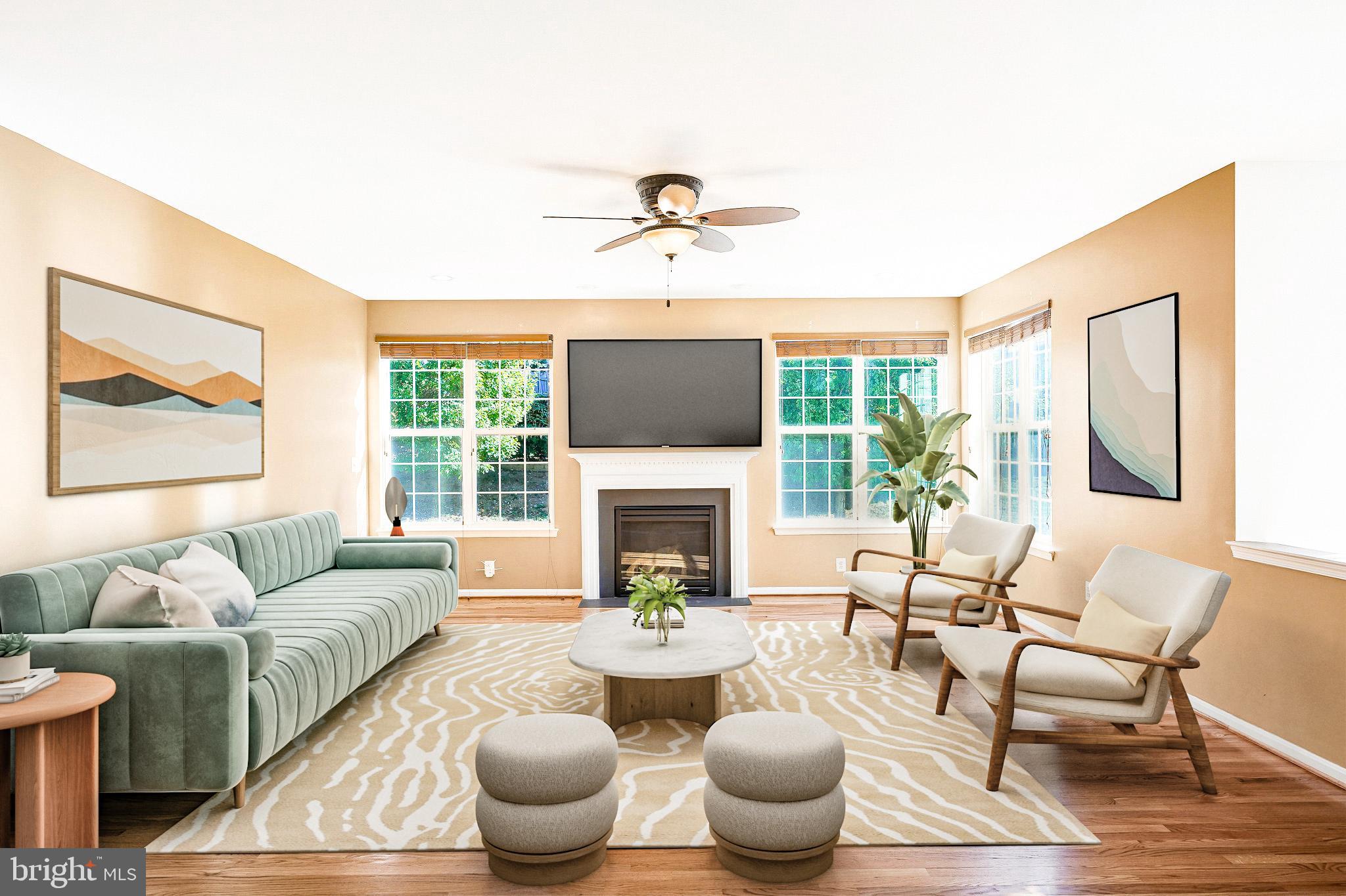 16012 Imperial Eagle Court Woodbridge, VA 22191 - Photo 2 of 25 a living room with furniture a fireplace and large windows