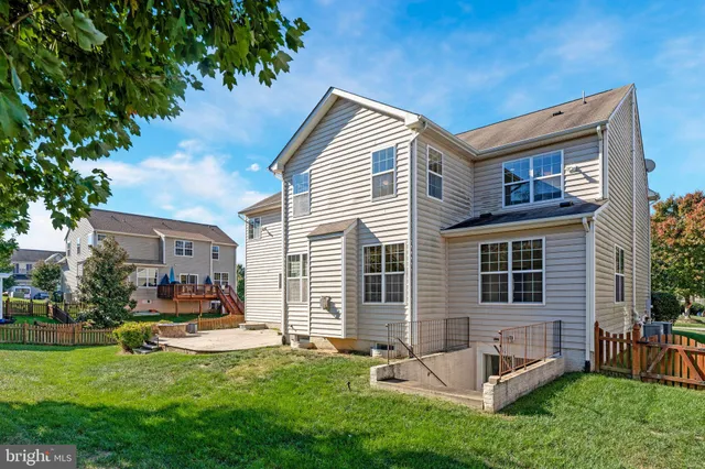 a view of house with a backyard