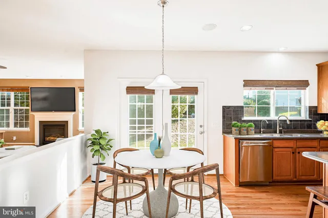 a dining room with furniture window wooden floor and a chandelier