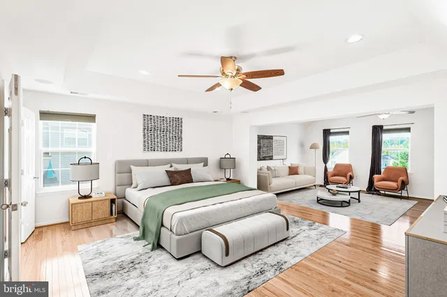 a bedroom with furniture and a large window