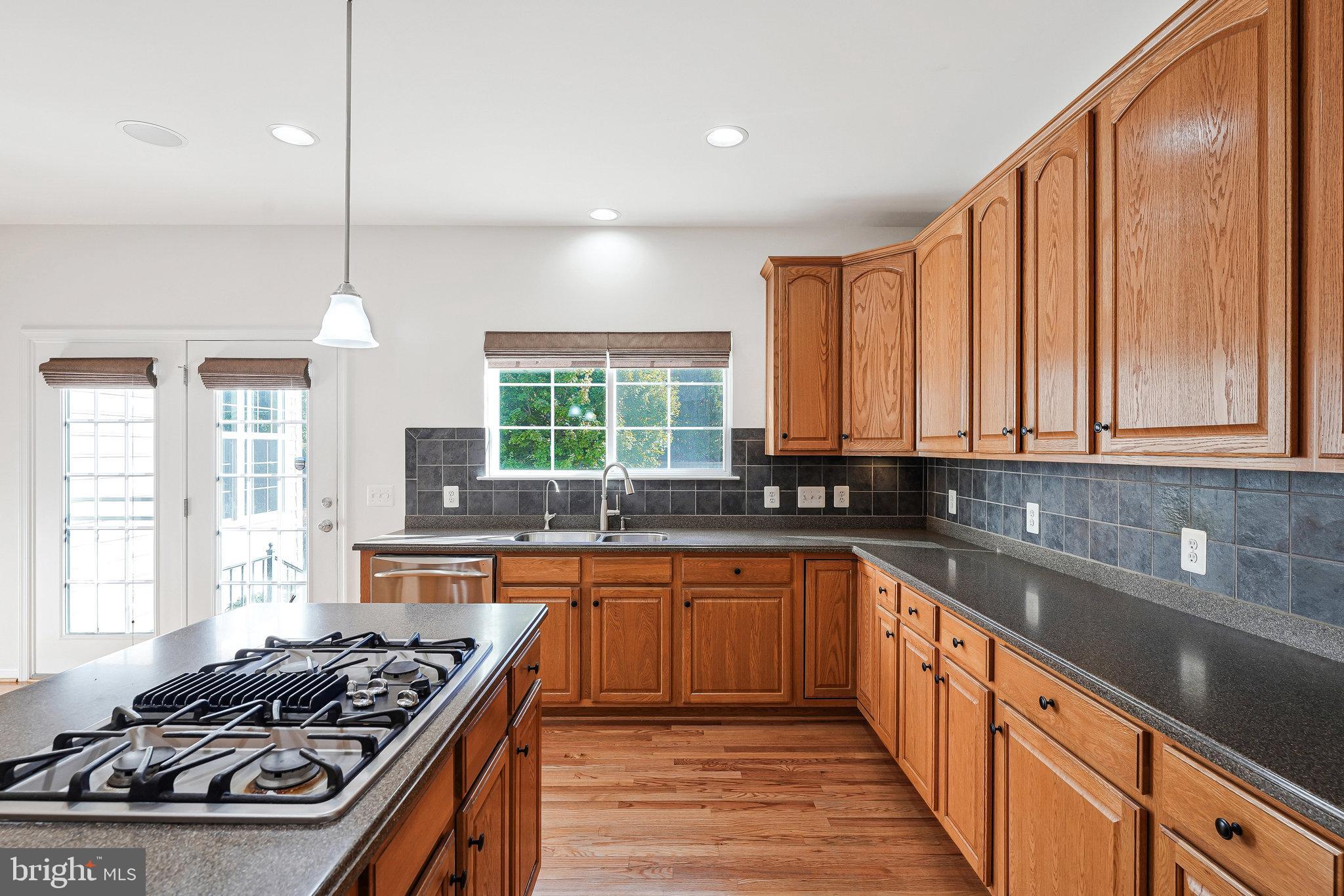 16012 Imperial Eagle Court Woodbridge, VA 22191 - Photo 7 of 25 a kitchen with stainless steel appliances a sink stove and cabinets