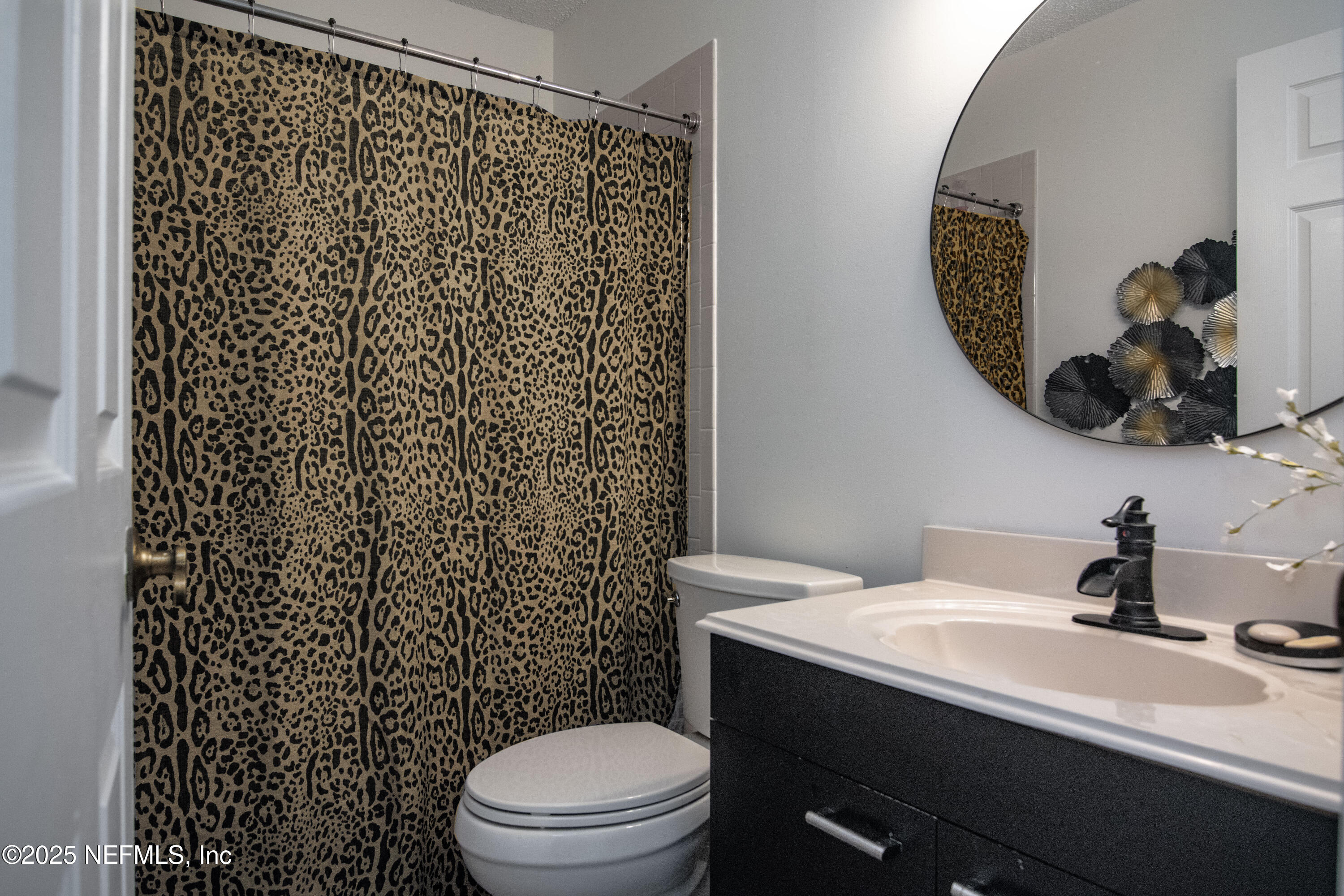 358 Monika Place St. Augustine, FL 32080 - Photo 19 of 32 a bathroom with a sink a toilet and shower curtain
