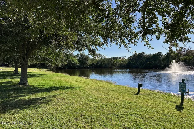 a view of a lake with outdoor seating and city view