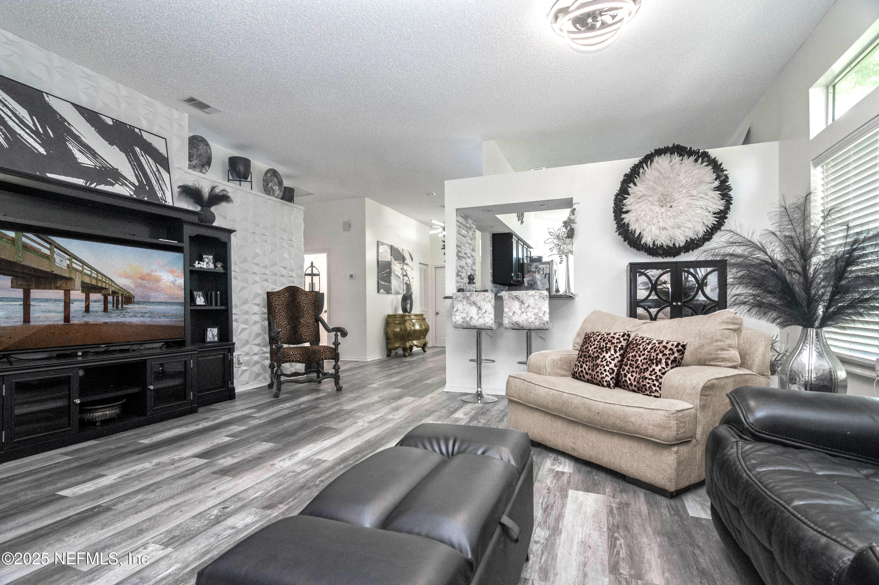 358 Monika Place St. Augustine, FL 32080 - Photo 6 of 32 a living room with furniture a wooden floor and a large window