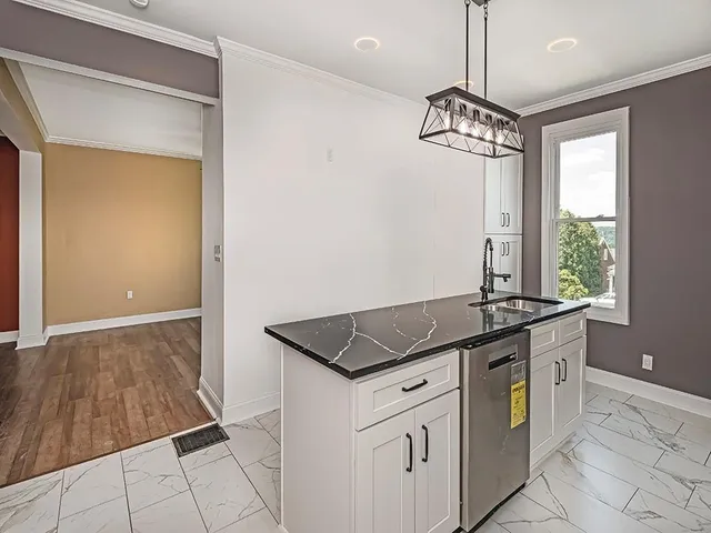 a kitchen with granite countertop a sink and a stove