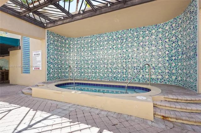 a view of a fountain with a bench in patio