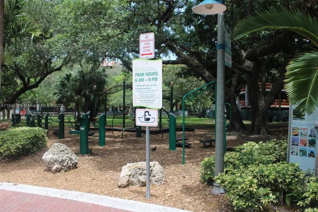 a front view of multi story residential apartment building with yard and green space