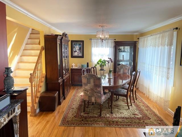 5 Bowser Road New Brunswick, NJ 08901 - Photo 15 of 45 a dining room with furniture a chandelier and wooden floor