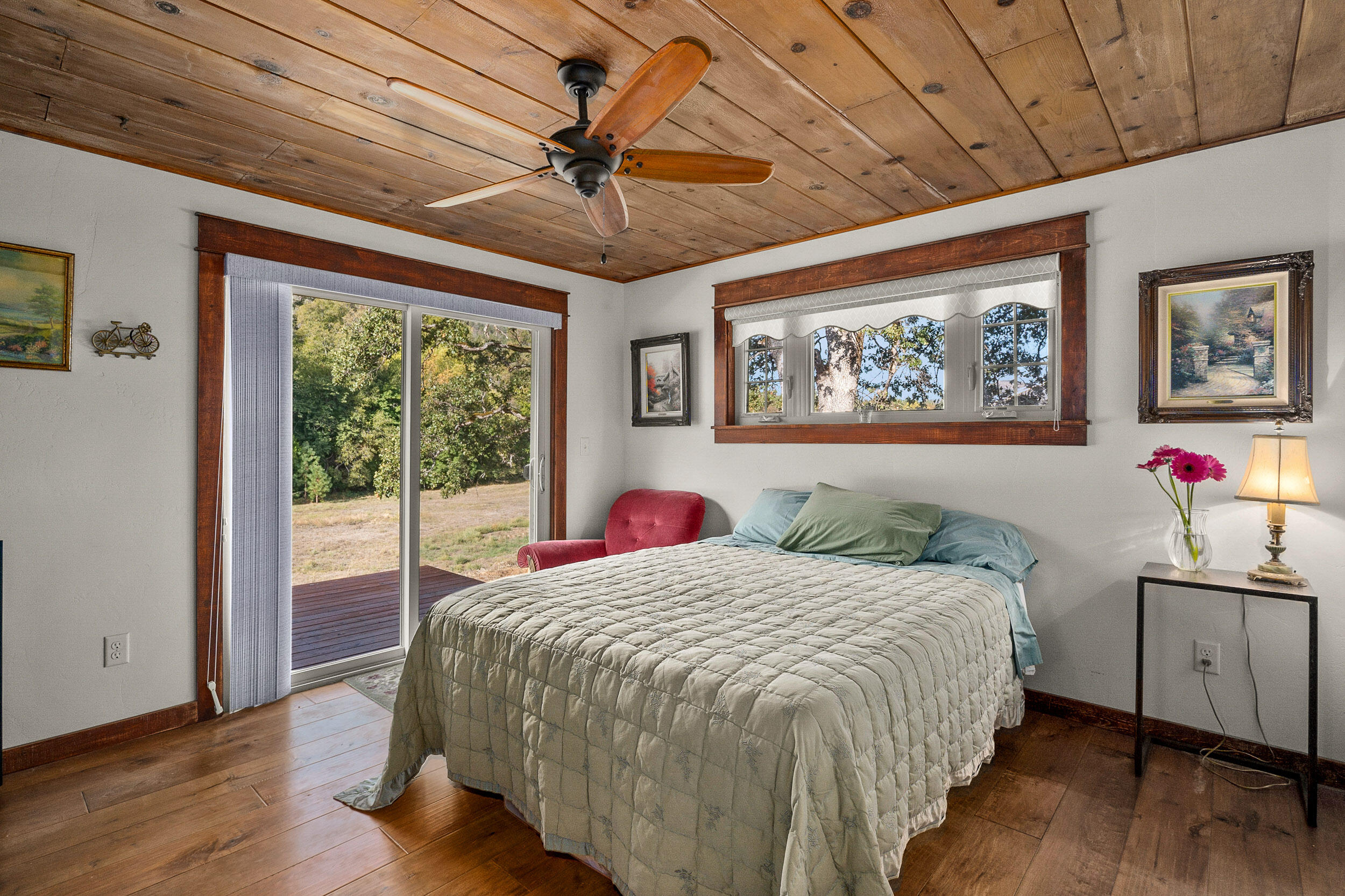3732-3786 Little Applegate Road Jacksonville, OR 97530 - Photo 15 of 72 a bedroom with a large bed and a chandelier