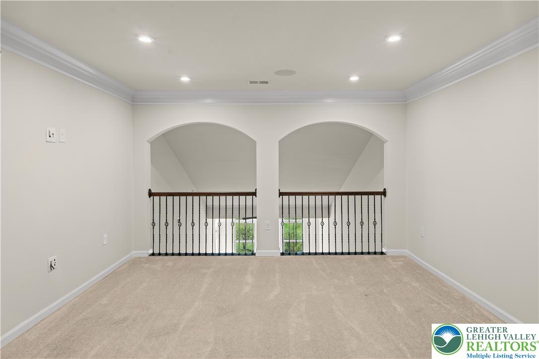 4758 Rafi Road Easton, PA 18045 - Photo 35 of 55 A versatile upper-level space features architectural archways and classic wrought iron railings overlooking the floor below.