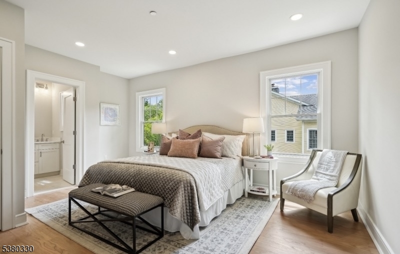 603 Springfield Avenue, Unit 104 Summit, NJ 07901 - Photo 6 of 6 a bedroom with a bed and wooden floor