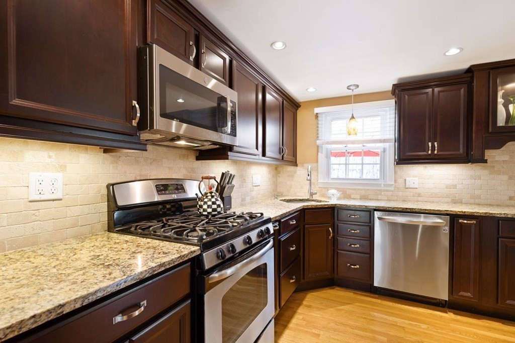 22 Kennedy Road Sharon, MA 02067 - Photo 12 of 41 a kitchen with stainless steel appliances granite countertop a stove a sink and a microwave