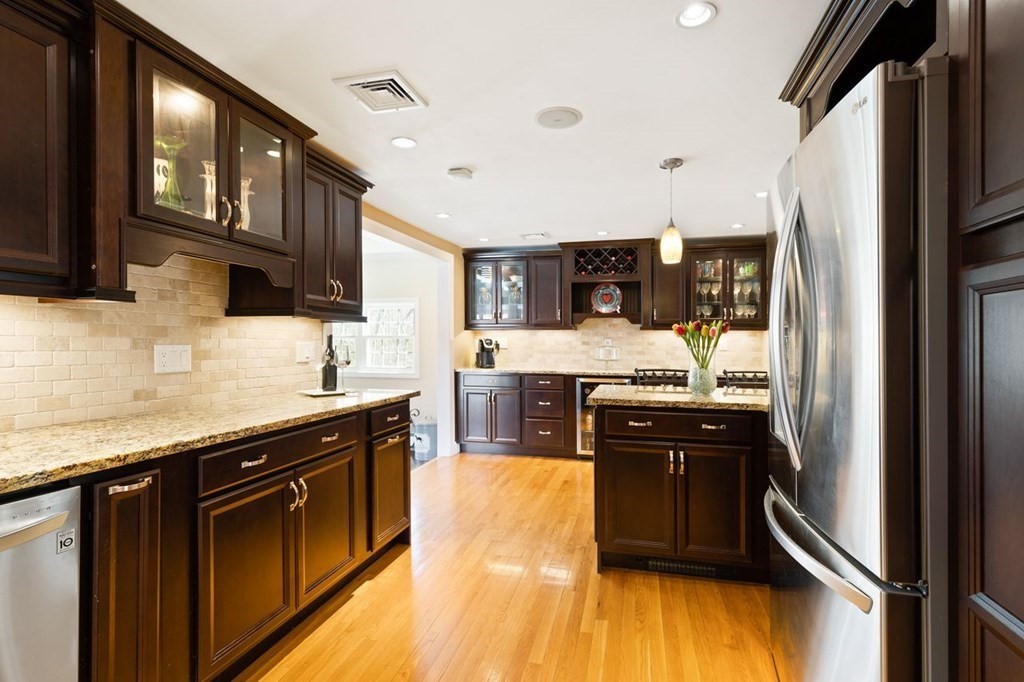 22 Kennedy Road Sharon, MA 02067 - Photo 13 of 41 a kitchen with stainless steel appliances granite countertop a refrigerator a stove top oven a sink and dishwasher