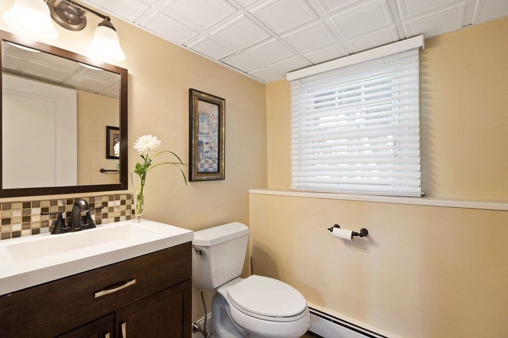 22 Kennedy Road Sharon, MA 02067 - Photo 29 of 41 a bathroom with a sink a toilet and a mirror