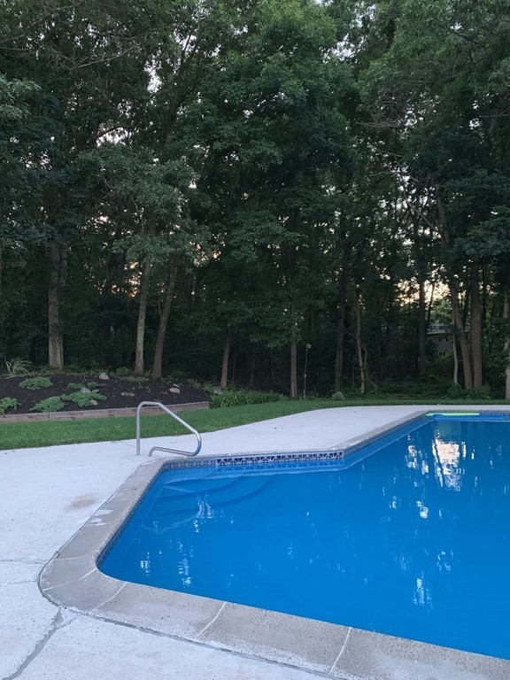 22 Kennedy Road Sharon, MA 02067 - Photo 35 of 41 a view of swimming pool with a yard and trees