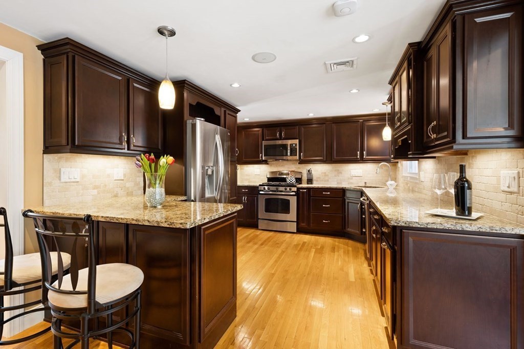 22 Kennedy Road Sharon, MA 02067 - Photo 10 of 41 a kitchen with stainless steel appliances granite countertop a sink counter space and cabinets
