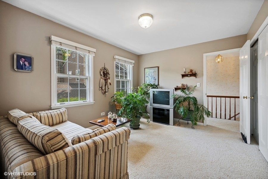 1612 Stonebridge Trail Wheaton, IL 60189 - Photo 14 of 22 a bedroom with a bed and windows