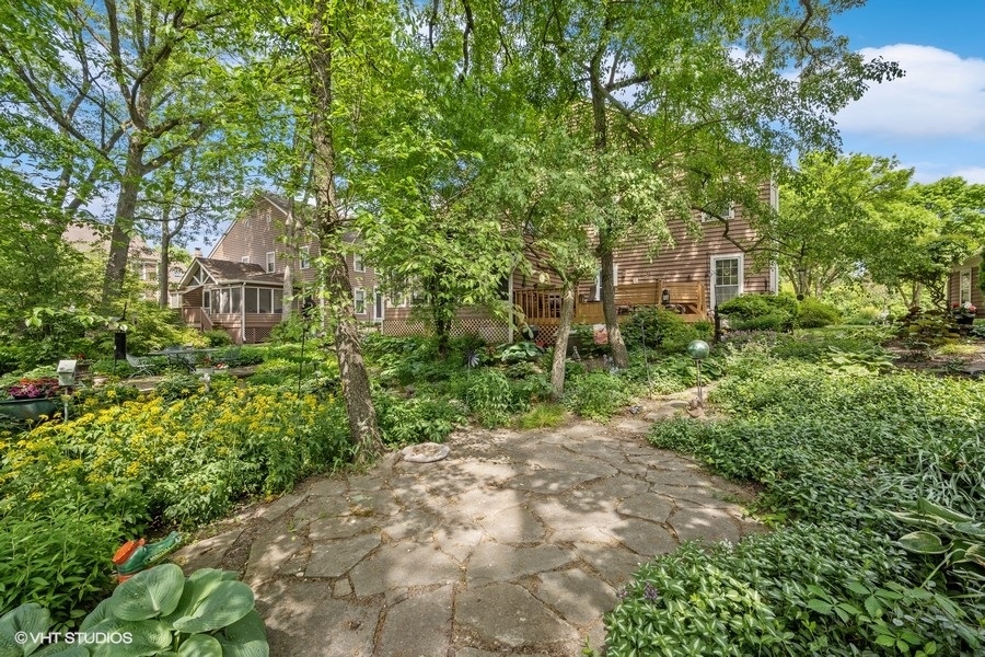 1612 Stonebridge Trail Wheaton, IL 60189 - Photo 20 of 22 a view of a garden with plants and large trees