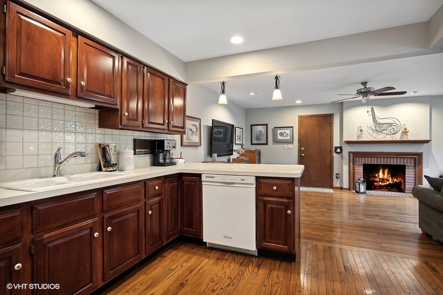 1612 Stonebridge Trail Wheaton, IL 60189 - Photo 7 of 22 a kitchen with a sink cabinets and wooden floor