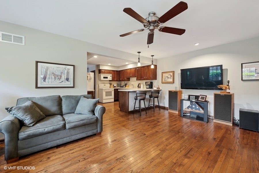 1612 Stonebridge Trail Wheaton, IL 60189 - Photo 10 of 22 a living room with furniture and a flat screen tv
