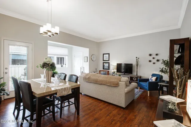 a view of a dining room with furniture and wooden floor