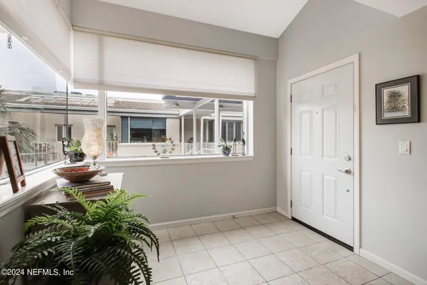 a view of balcony with chairs and potted plants