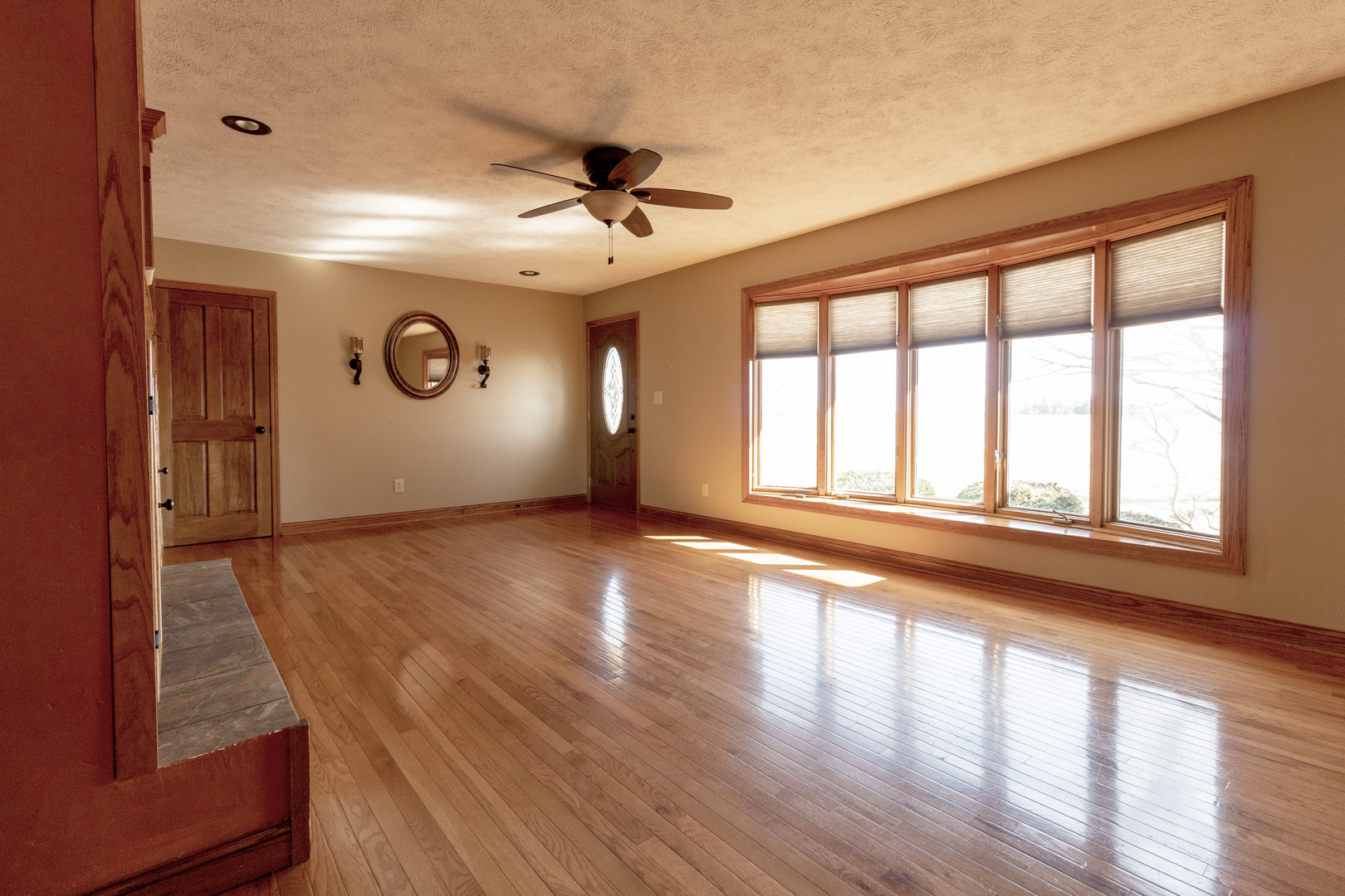 1455 North Gorham Road Morris, IL 60450 - Photo 3 of 22 a view of an empty room with a window and wooden floor