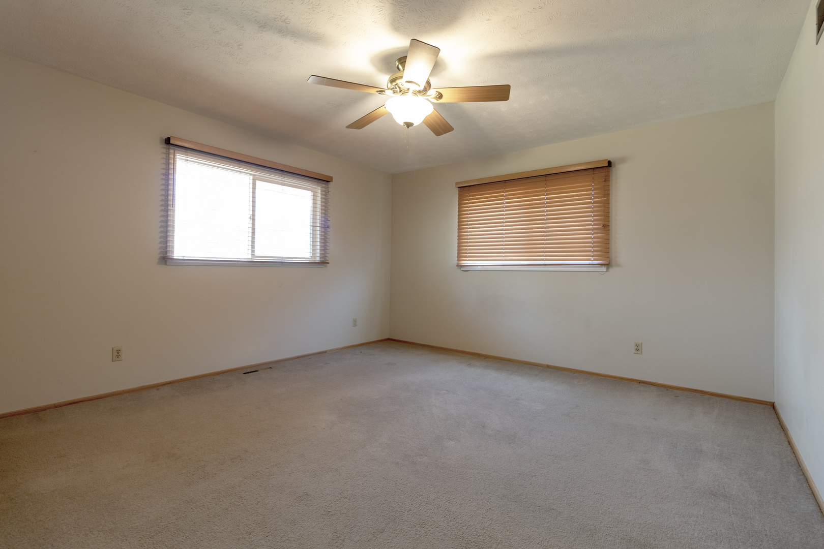 1455 North Gorham Road Morris, IL 60450 - Photo 9 of 22 an empty room with a chandelier fan and windows