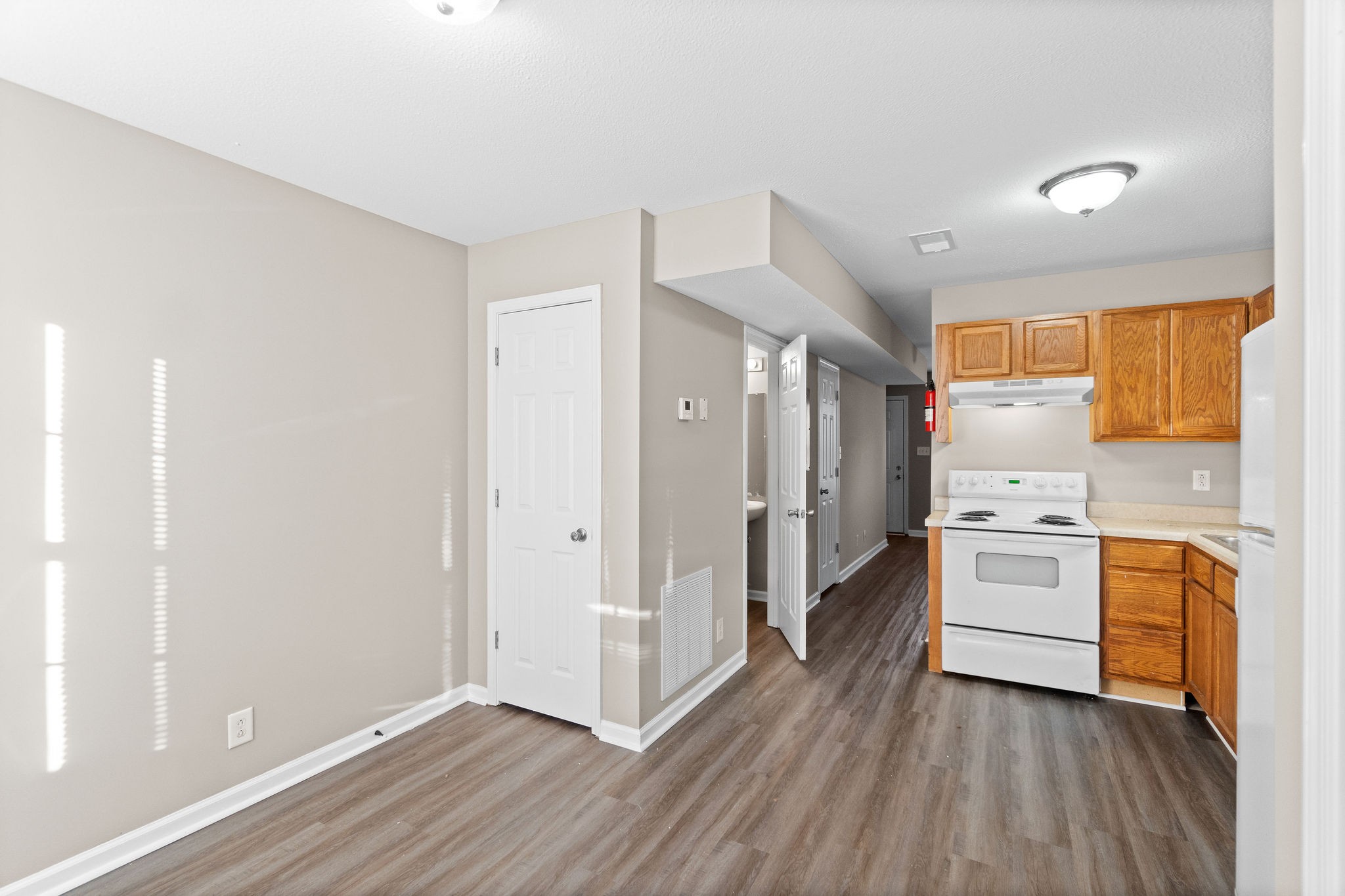 804 Golf View Place, Unit B Clarksville, TN 37043 - Photo 17 of 24 a kitchen with white cabinets and wooden floor