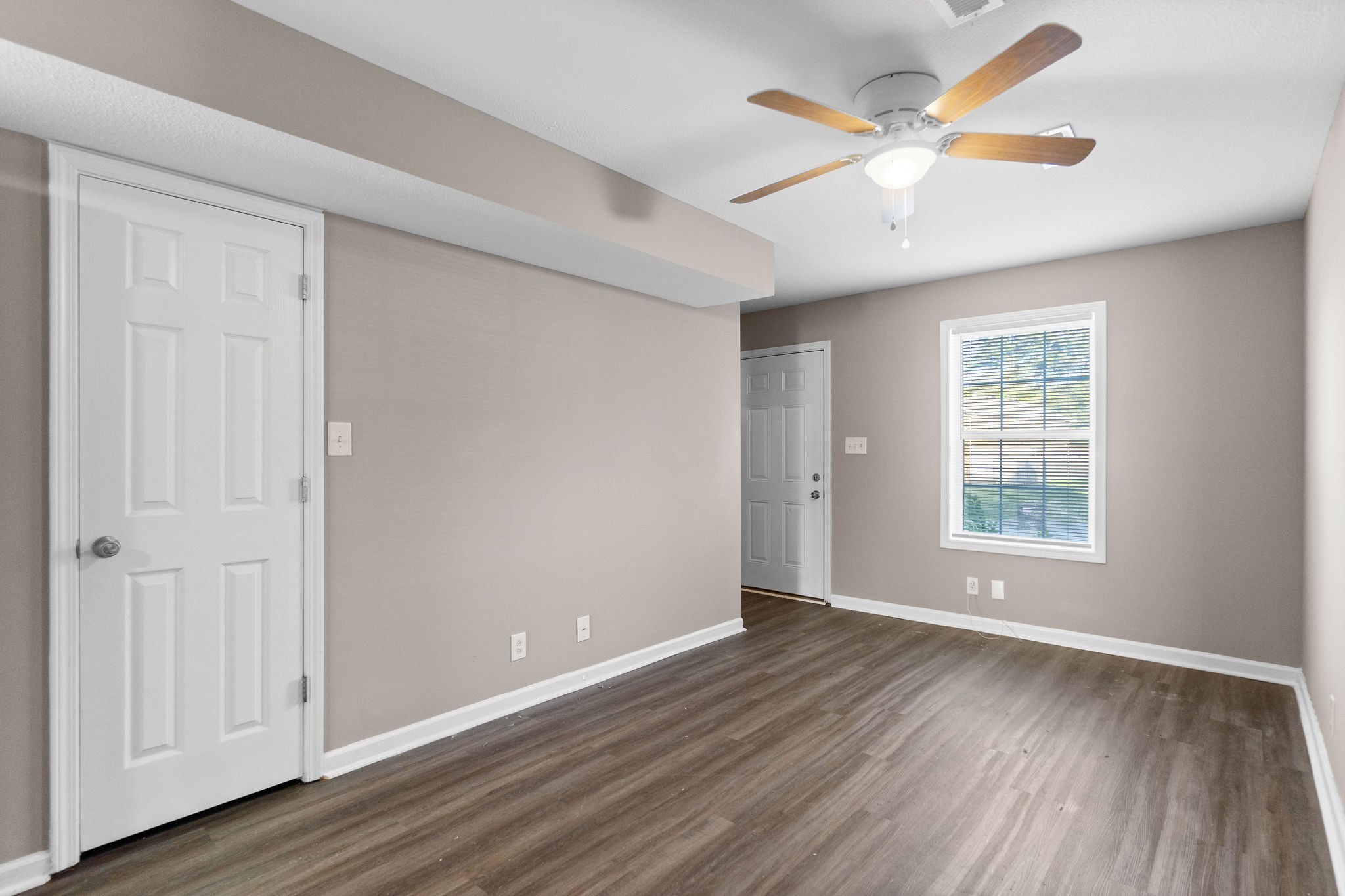 804 Golf View Place, Unit B Clarksville, TN 37043 - Photo 6 of 24 an empty room with wooden floor chandelier fan and windows