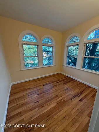 wooden floor in an empty room with window