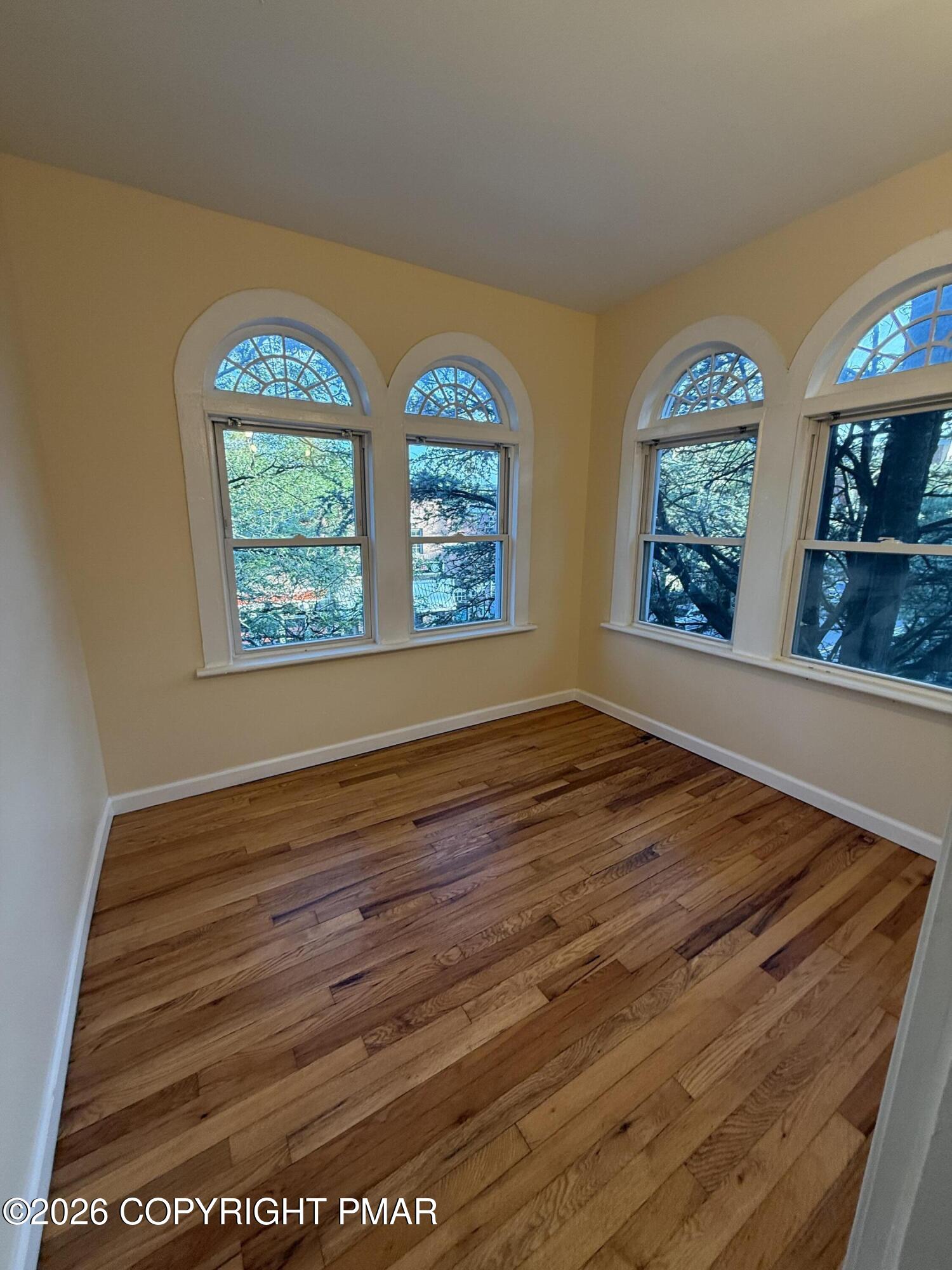526 Main Street, Unit 2 Stroudsburg, PA 18360 - Photo 5 of 9 wooden floor in an empty room with window