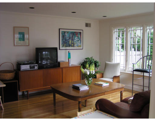 14 Plowgate Road Brookline, MA 02467 - Photo 4 of 6 a living room with furniture a flat screen tv and a potted plant