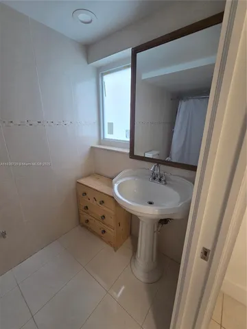 a bathroom with a sink and a window