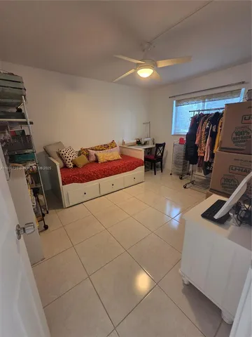 a bedroom with furniture and a air conditioner vent